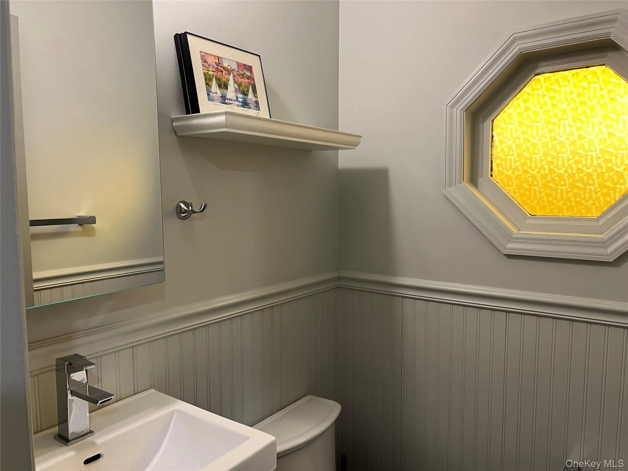 Half bath with a wainscoted wall Half bath with a wainscoted wall