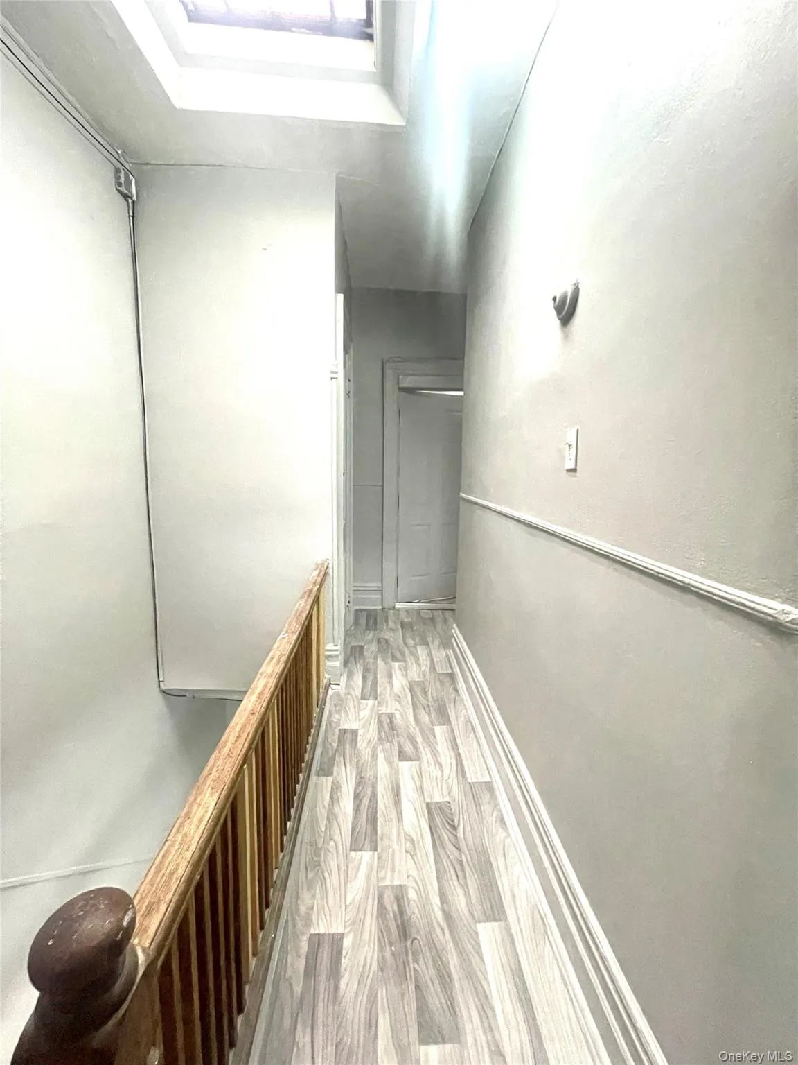 Hall with light wood-style floors and baseboards Hall with light wood-style floors and baseboards