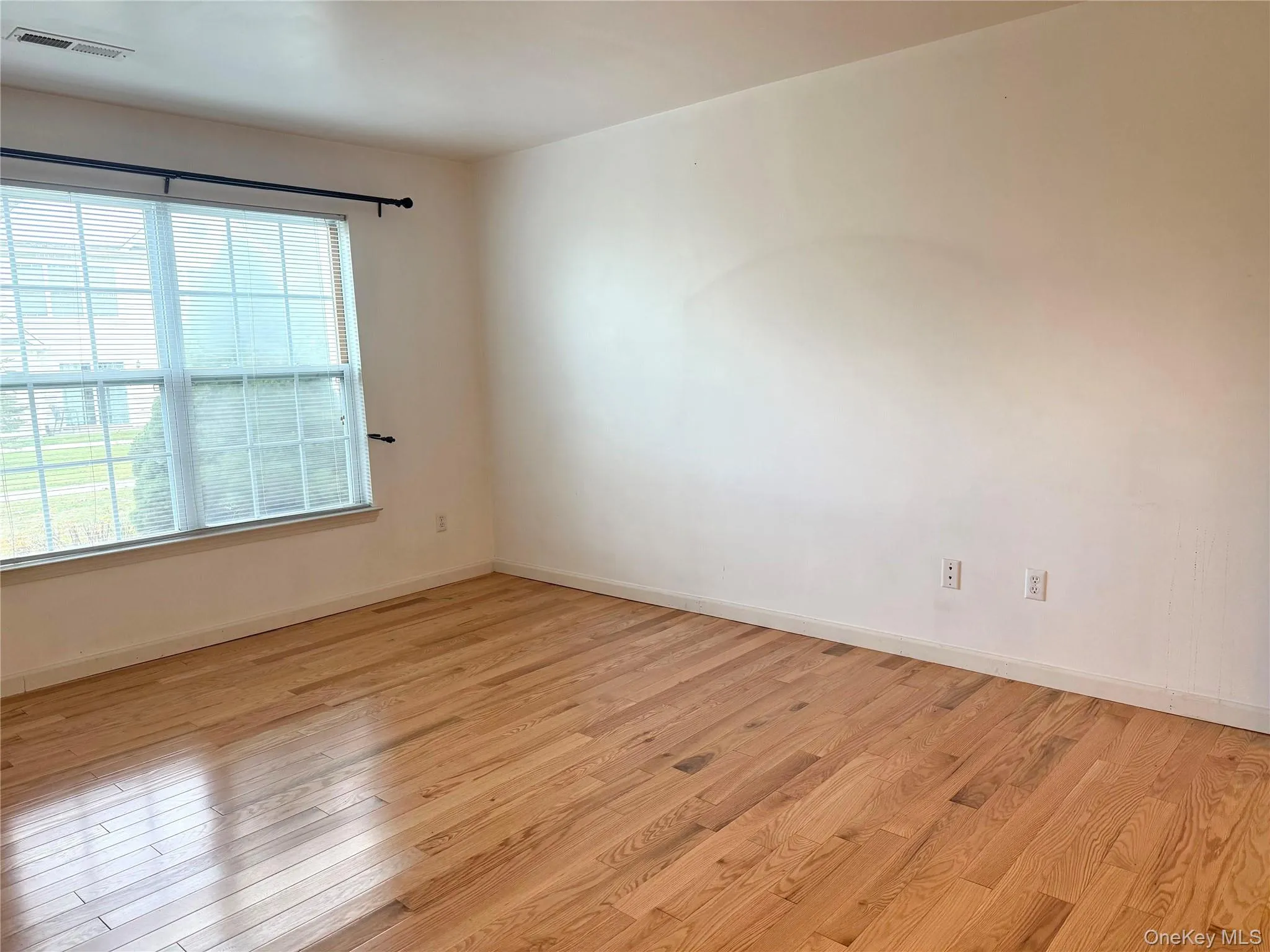 Unfurnished room with light wood-type flooring Unfurnished room with light wood-type flooring