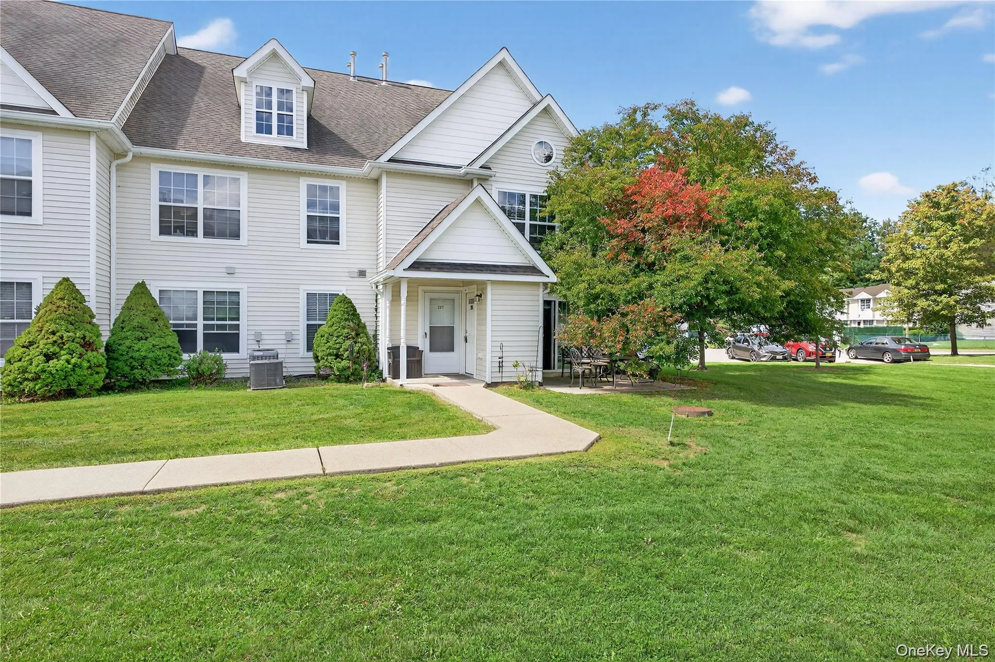 Traditional-style home featuring a shingled roof and a front lawn Traditional-style home featuring a shingled roof and a front lawn