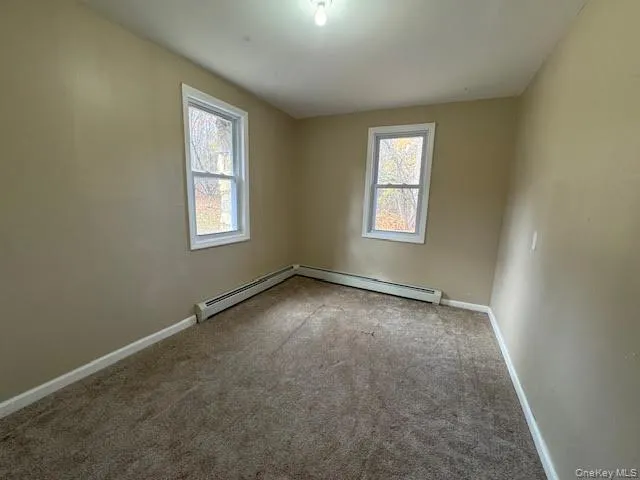 Bedroom #3 featuring carpet flooring, baseboard heating and 2 windows. Bedroom #3 featuring carpet flooring, baseboard heating and 2 windows.
