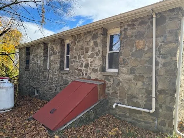 Back of the house with entry door to the basement. Back of the house with entry door to the basement.