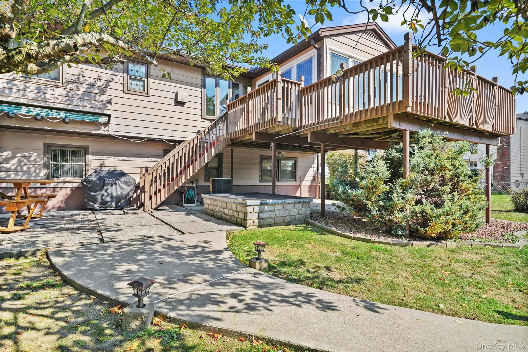 Back of house featuring a deck and stairway. Back of house featuring a deck and stairway.