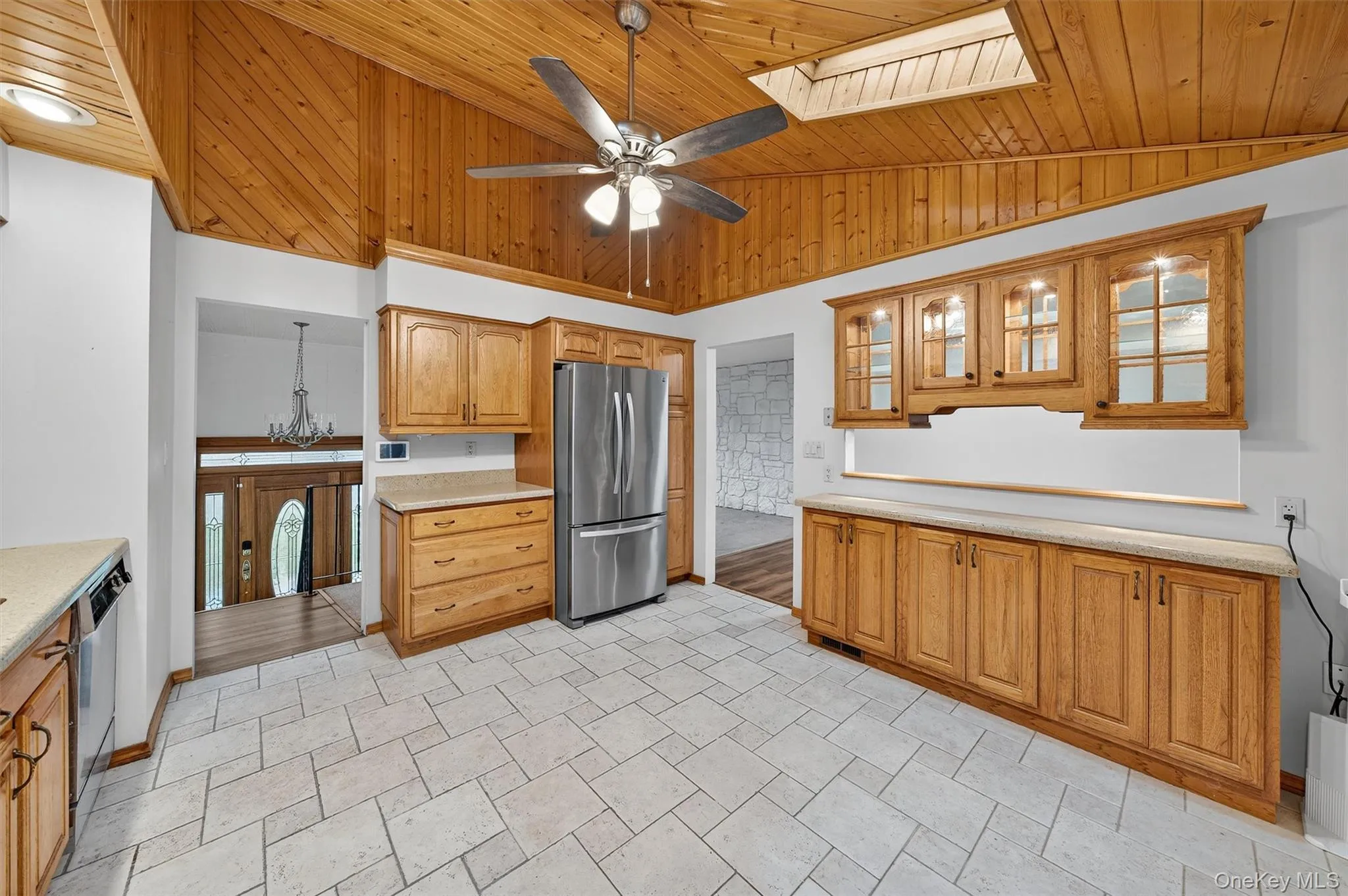 Kitchen featuring a skylight, vaulted ceiling, stainless steel appliances. Kitchen featuring a skylight, vaulted ceiling, stainless steel appliances.