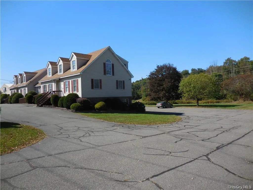 View of the side of the building and the paved parking area. View of the side of the building and the paved parking area.