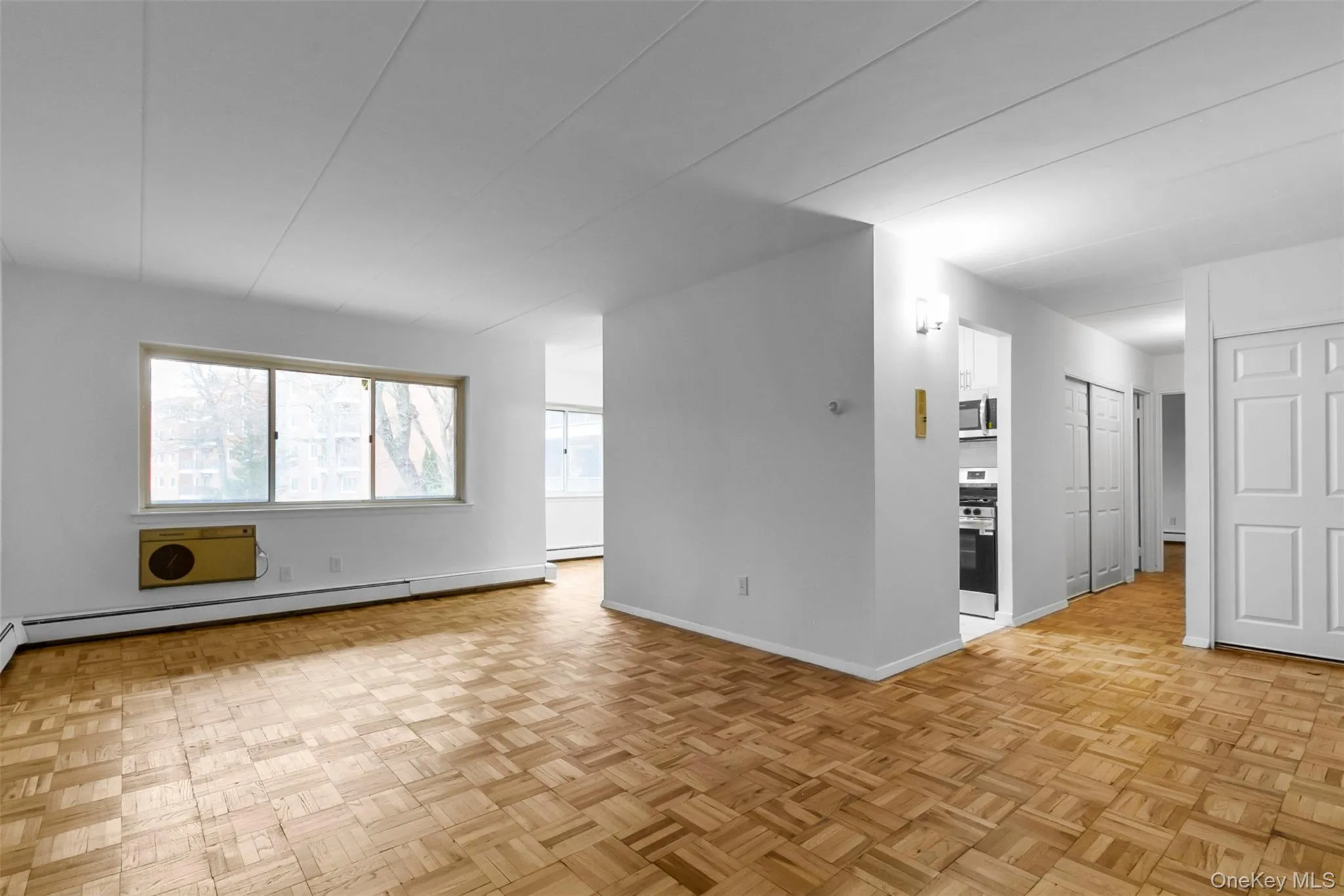 Empty room with a wall mounted air conditioner and a baseboard radiator Empty room with a wall mounted air conditioner and a baseboard radiator