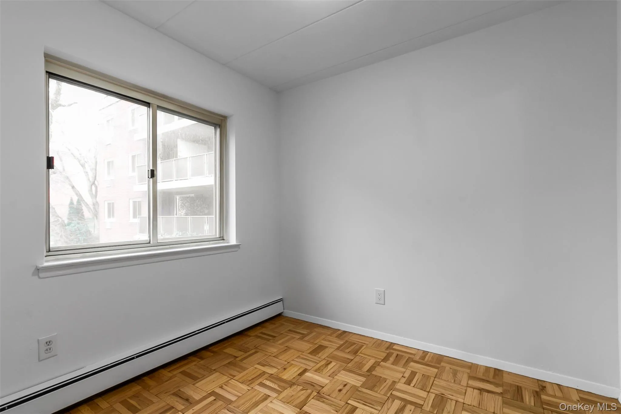 Empty room with a baseboard heating unit and baseboards Empty room with a baseboard heating unit and baseboards