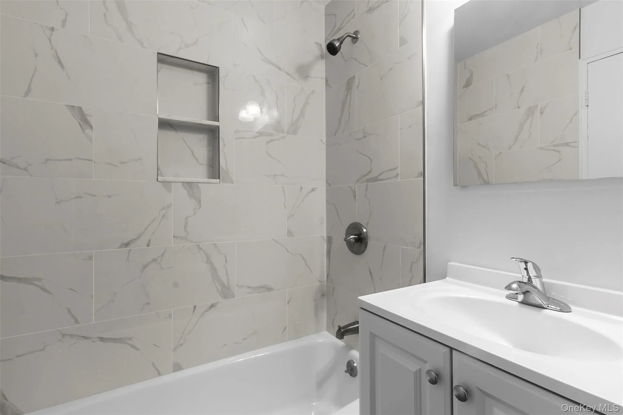 Full bathroom with vanity and shower / bath combination Full bathroom with vanity and shower / bath combination