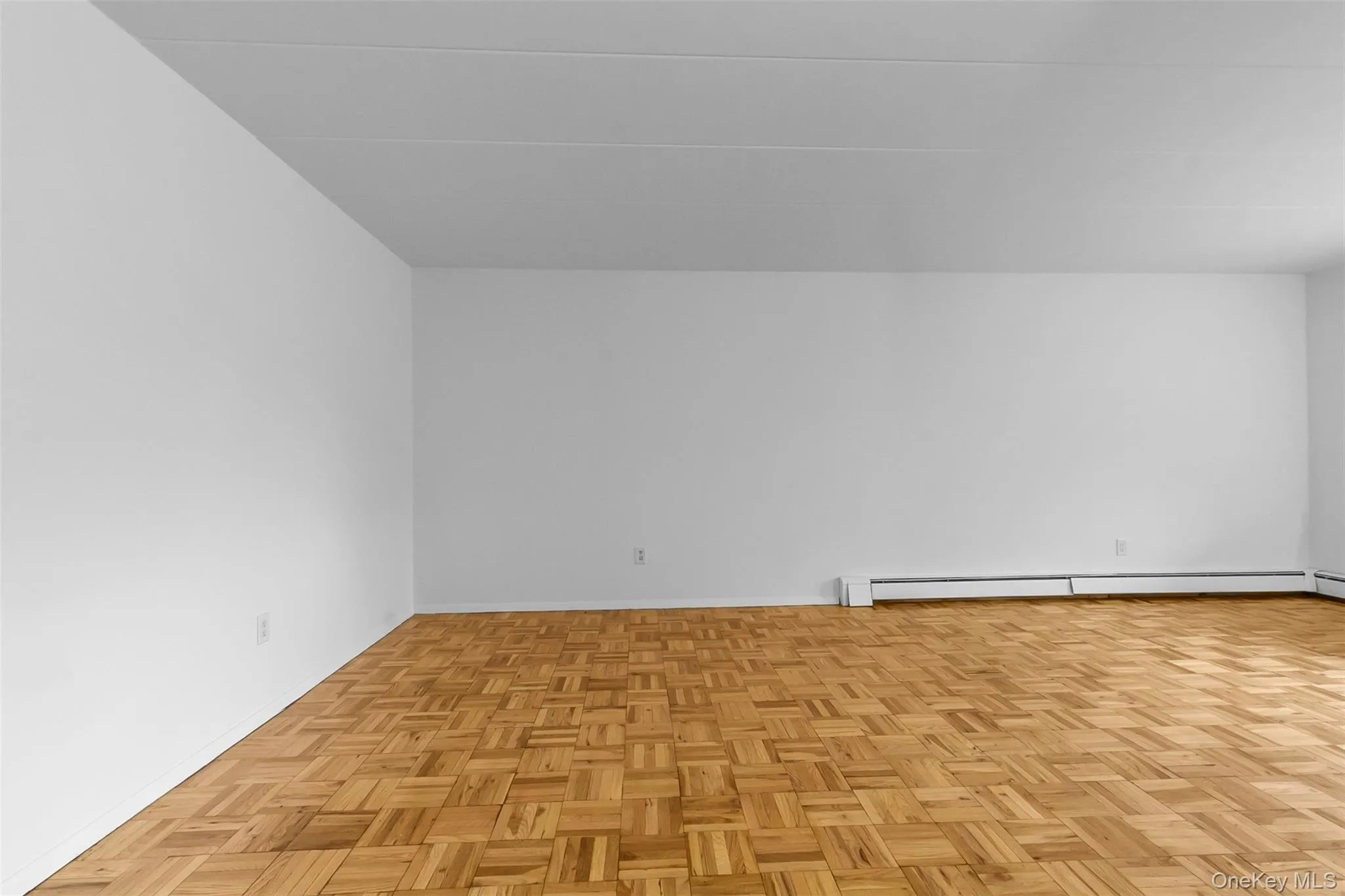Empty room featuring baseboards and baseboard heating Empty room featuring baseboards and baseboard heating