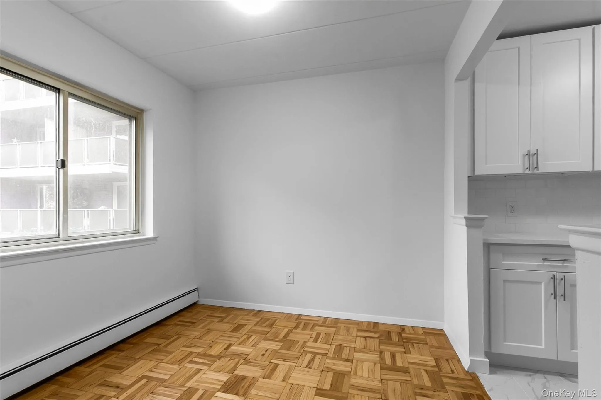 Unfurnished dining area with a baseboard heating unit and baseboards Unfurnished dining area with a baseboard heating unit and baseboards