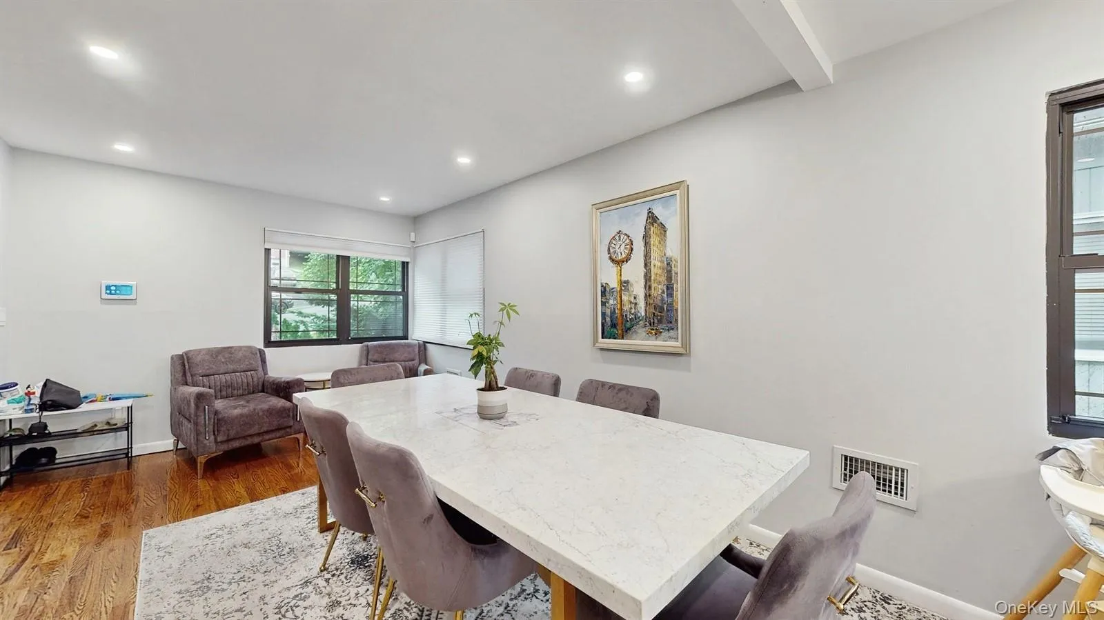 Dining room with dark wood-style floors and recessed lighting Dining room with dark wood-style floors and recessed lighting
