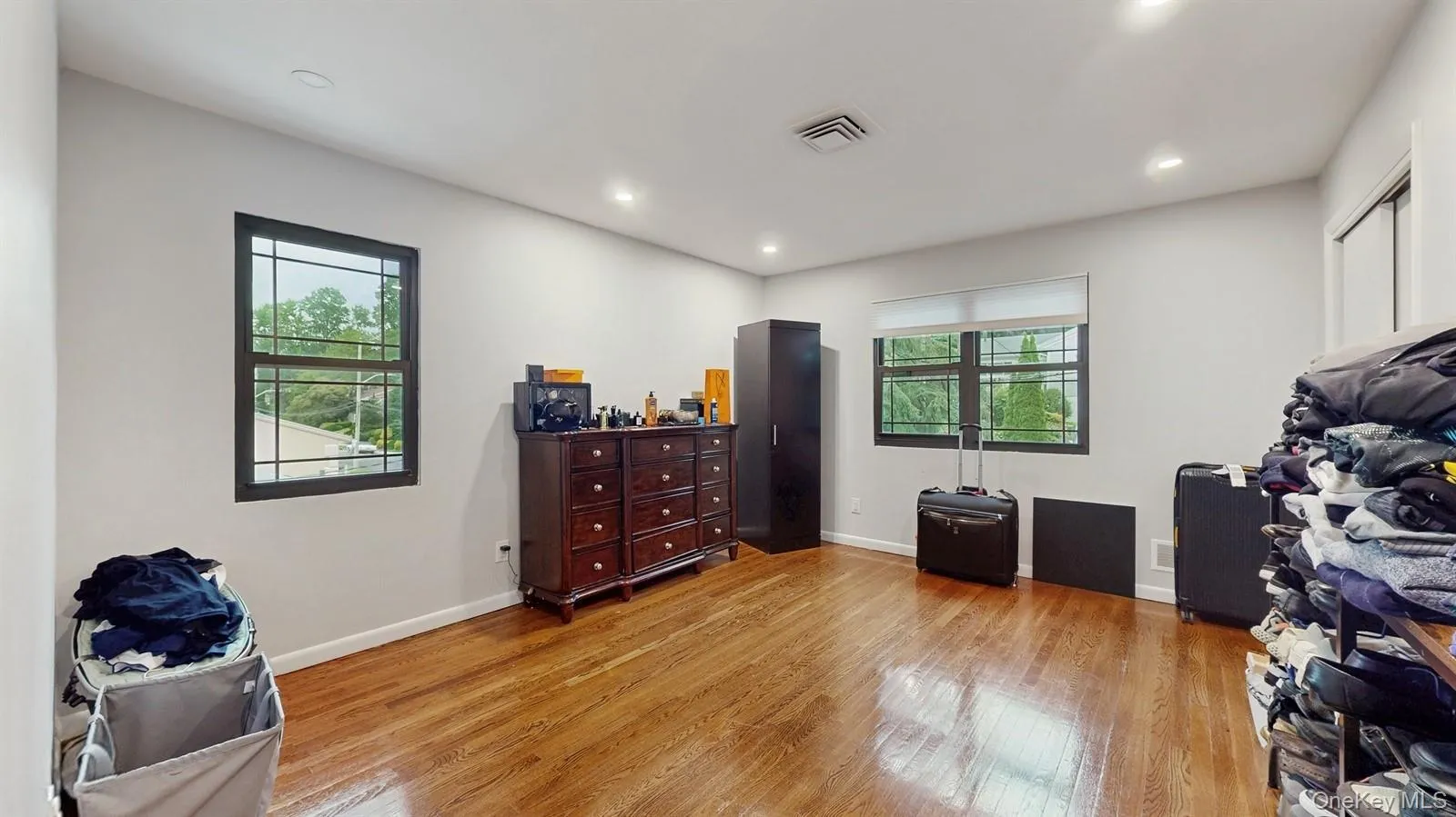 Bedroom featuring light hardwood floors, closet and recessed lighting Bedroom featuring light hardwood floors, closet and recessed lighting