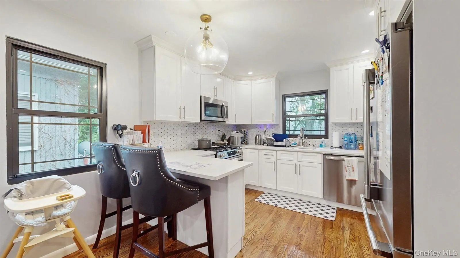 Large Kitchen, featuring stainless steel appliances, a peninsula, with Quartz Counter tops, lots of white cabinets, and recessed lighting Large Kitchen, featuring stainless steel appliances, a peninsula, with Quartz Counter tops, lots of white cabinets, and recessed lighting