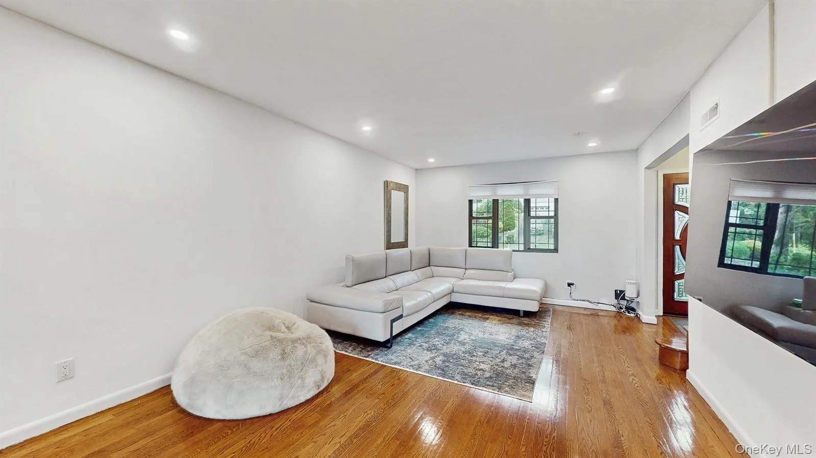 Living area featuring wood finished floors and recessed lighting. Living area featuring wood finished floors and recessed lighting.