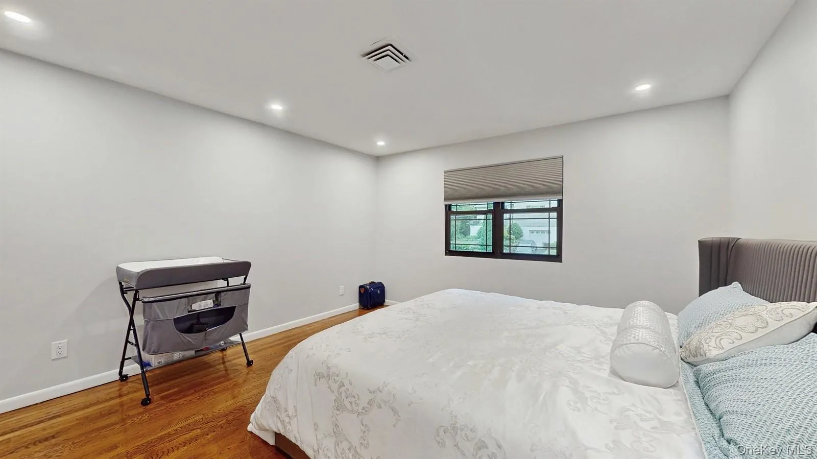 Bedroom with recessed lighting, closet and wood finished floors. Bedroom with recessed lighting, closet and wood finished floors.