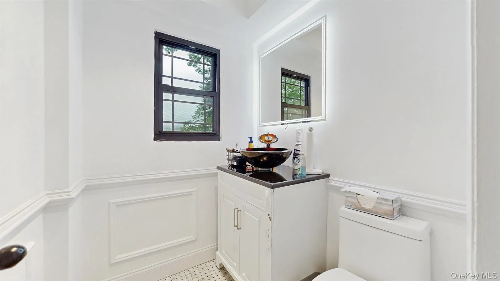 Very Nice Half Bathroom/Powder Room featuring vanity, a wainscoted wall, and a decorative wall. Very Nice Half Bathroom/Powder Room featuring vanity, a wainscoted wall, and a decorative wall.
