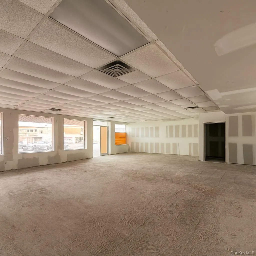 Carpeted empty room with a paneled ceiling Carpeted empty room with a paneled ceiling