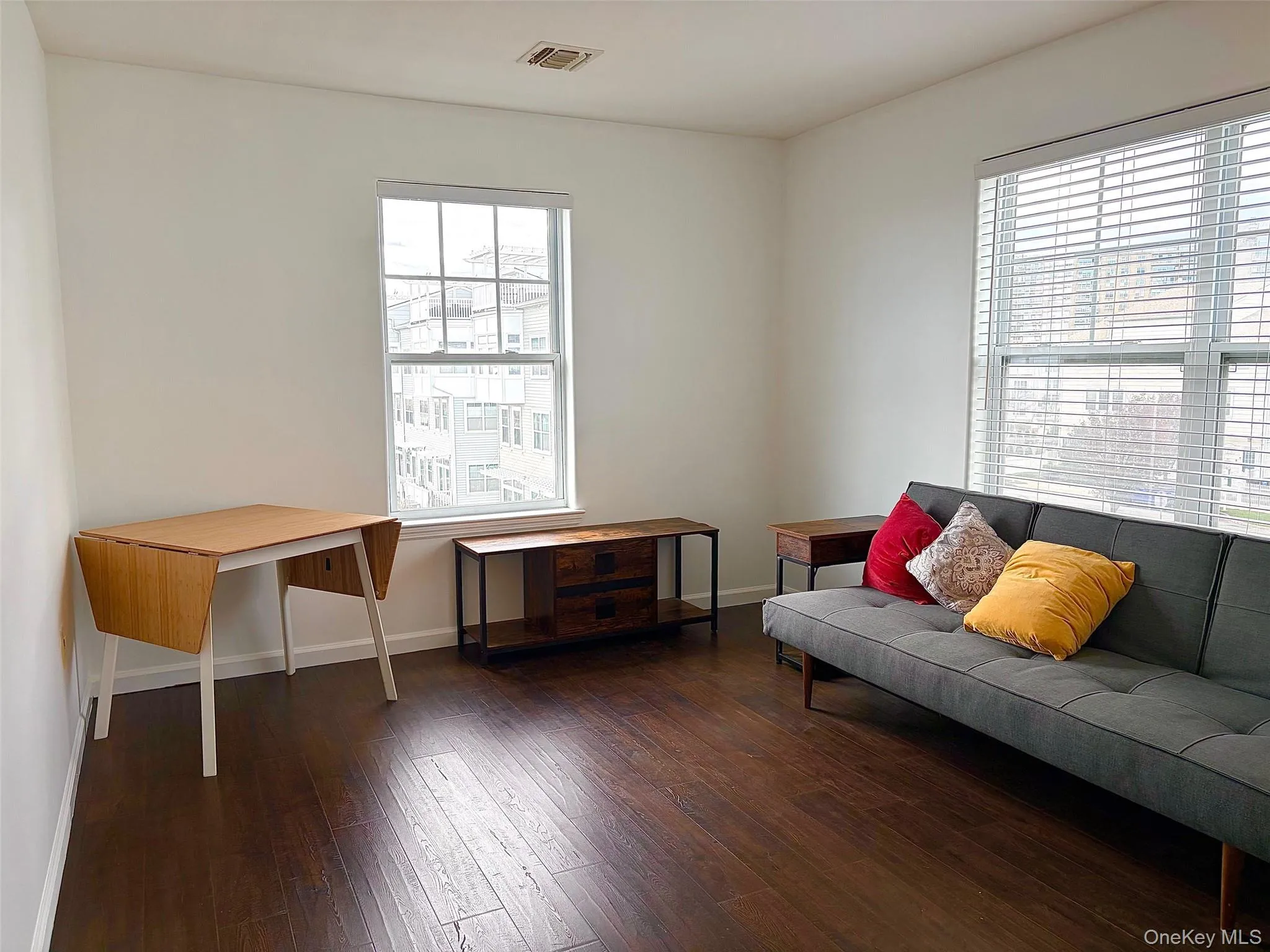 Sitting room with dark wood finished floors and baseboards Sitting room with dark wood finished floors and baseboards