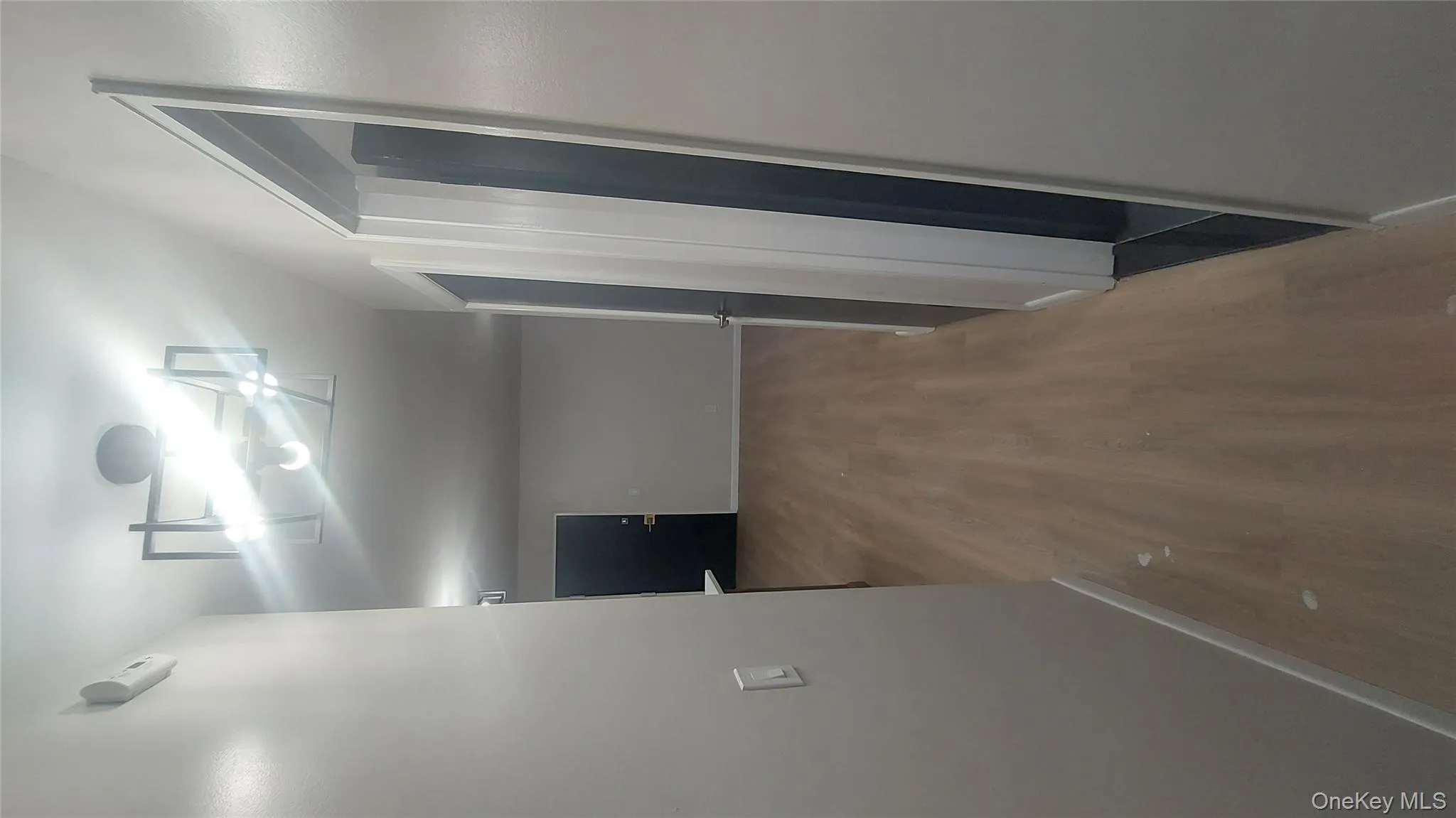 Corridor with baseboards and wood finished floors Corridor with baseboards and wood finished floors