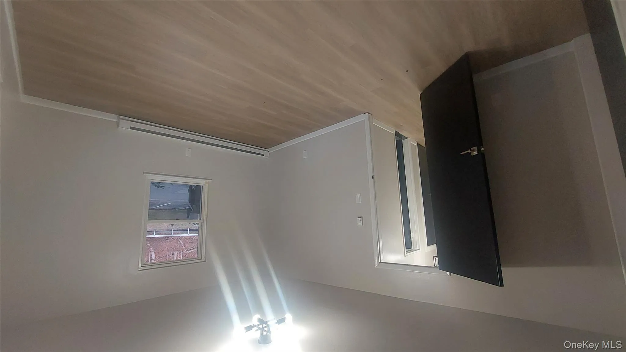 Empty room featuring light wood-type flooring and baseboard heating Empty room featuring light wood-type flooring and baseboard heating