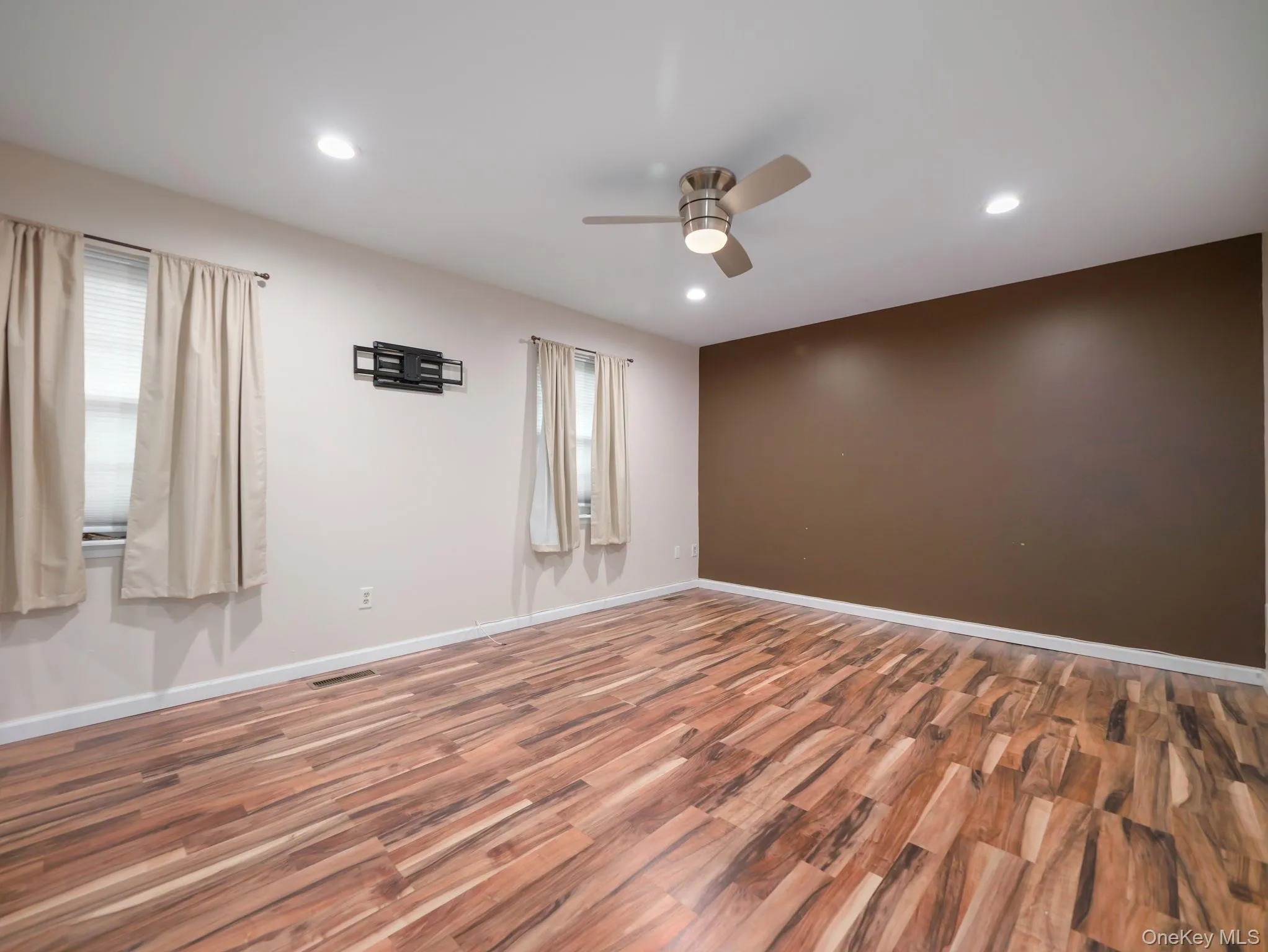 Unfurnished room featuring wood finished floors, recessed lighting, and a ceiling fan Unfurnished room featuring wood finished floors, recessed lighting, and a ceiling fan