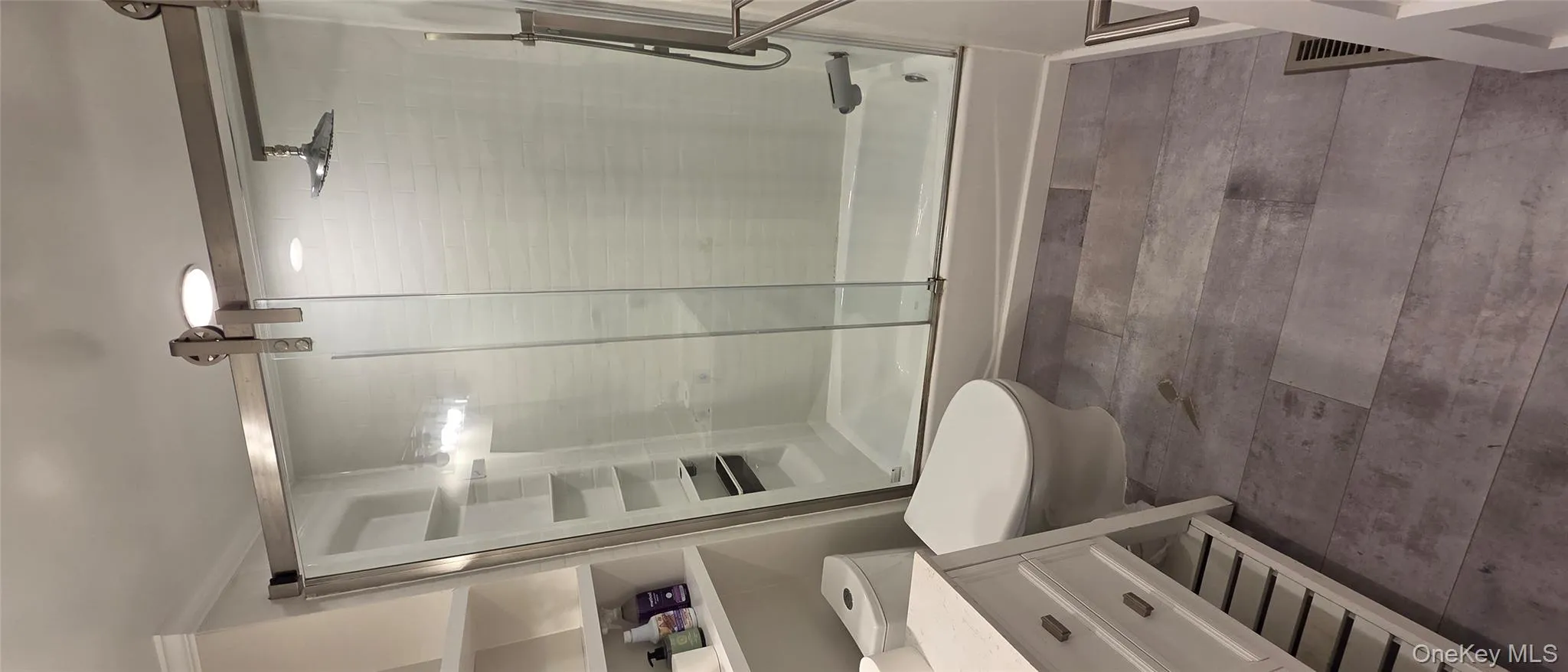 Full bath featuring toilet and enclosed tub / shower combo Full bath featuring toilet and enclosed tub / shower combo