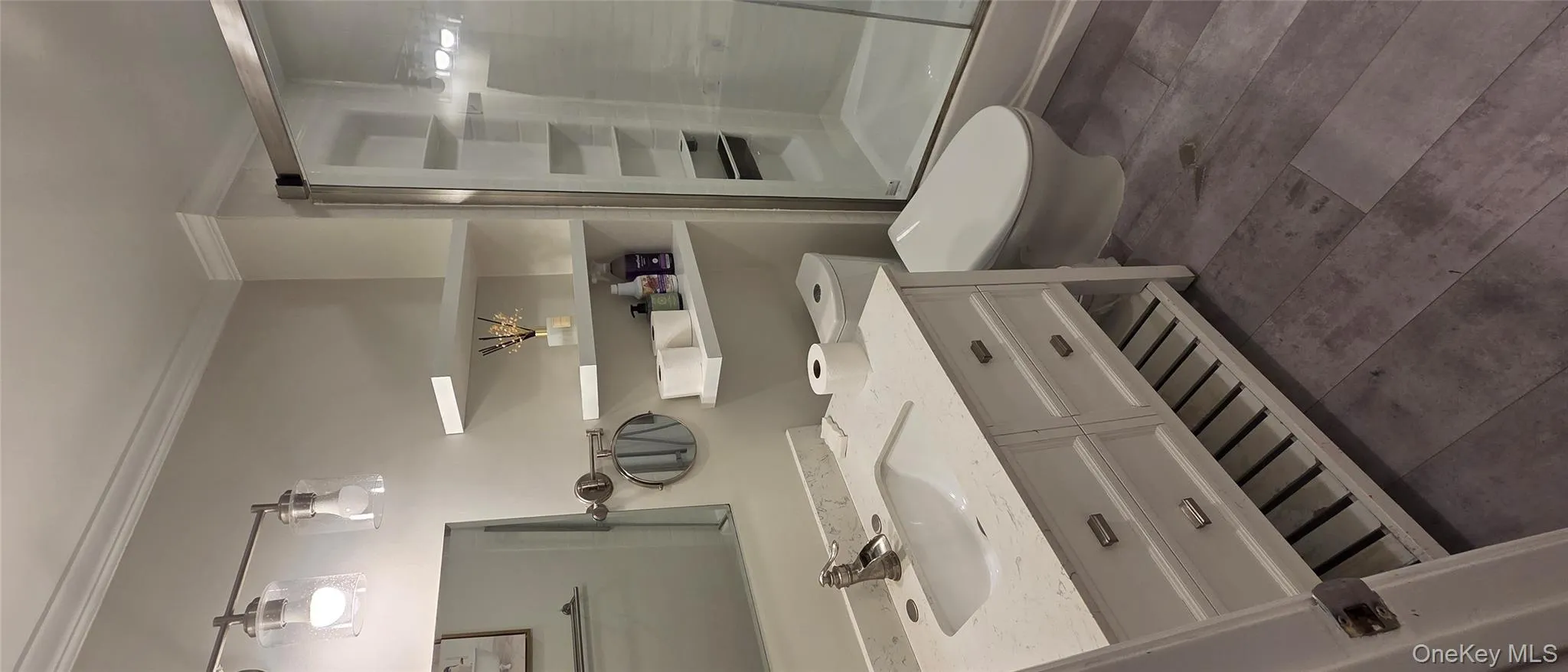 Full bath featuring crown molding, vanity, and a shower stall Full bath featuring crown molding, vanity, and a shower stall