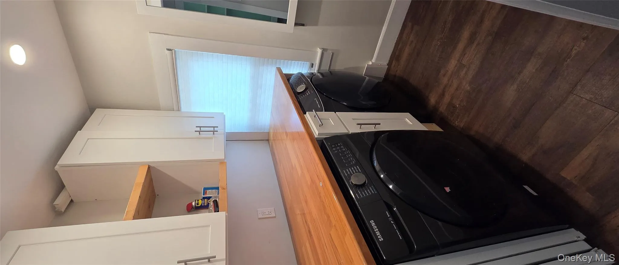 Washroom with cabinet space, dark wood finished floors, recessed lighting, and washer and clothes dryer Washroom with cabinet space, dark wood finished floors, recessed lighting, and washer and clothes dryer