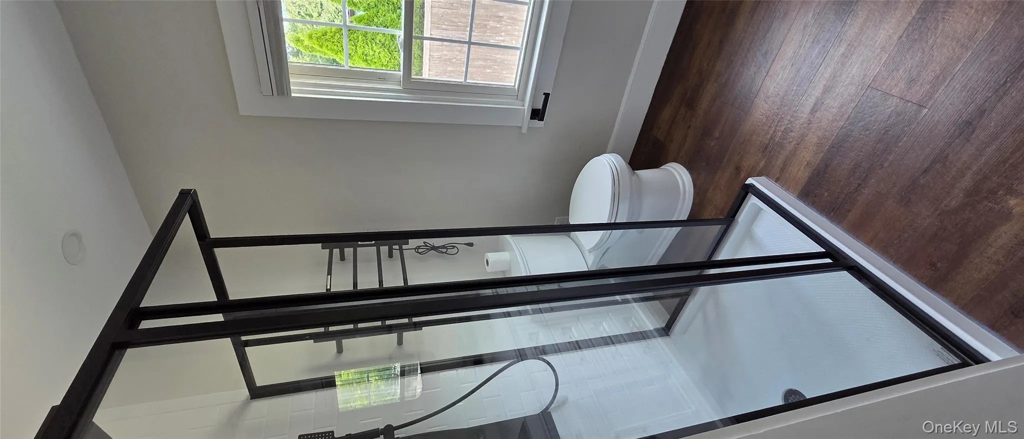 Full bathroom with dark wood-type flooring and a shower stall Full bathroom with dark wood-type flooring and a shower stall