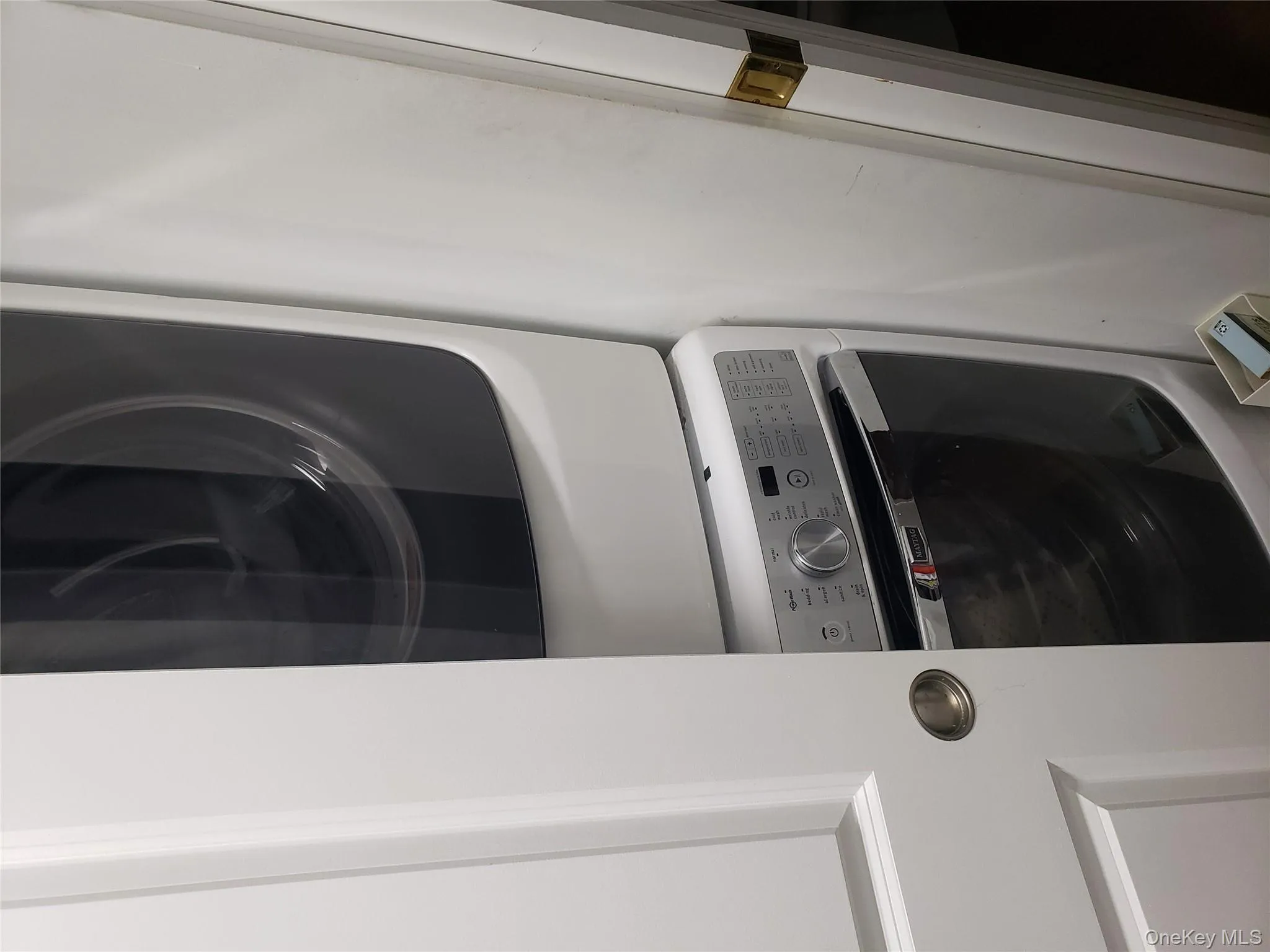 Laundry room featuring stacked washer / dryer and laundry area Laundry room featuring stacked washer / dryer and laundry area
