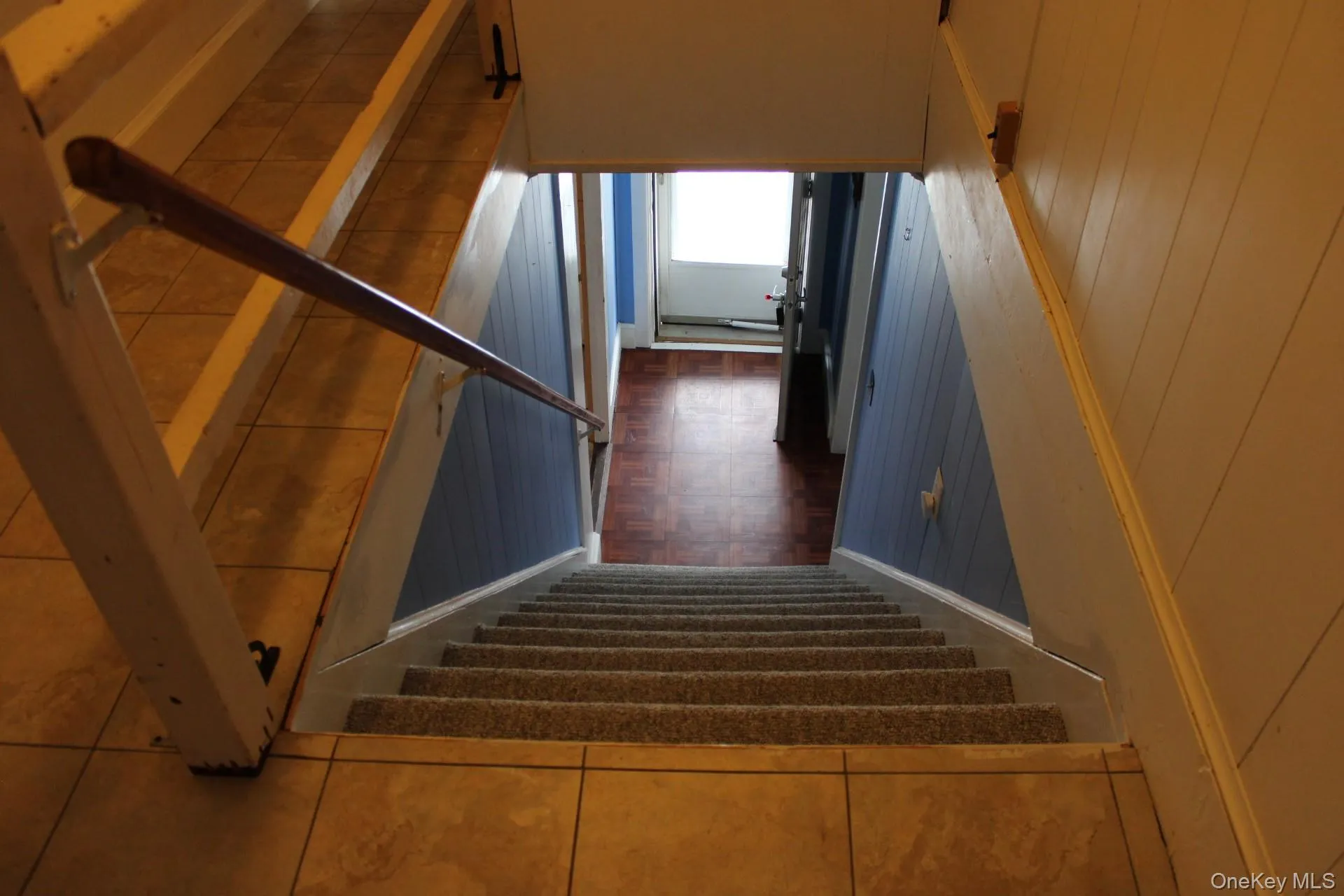 Staircase featuring tile patterned floors Staircase featuring tile patterned floors