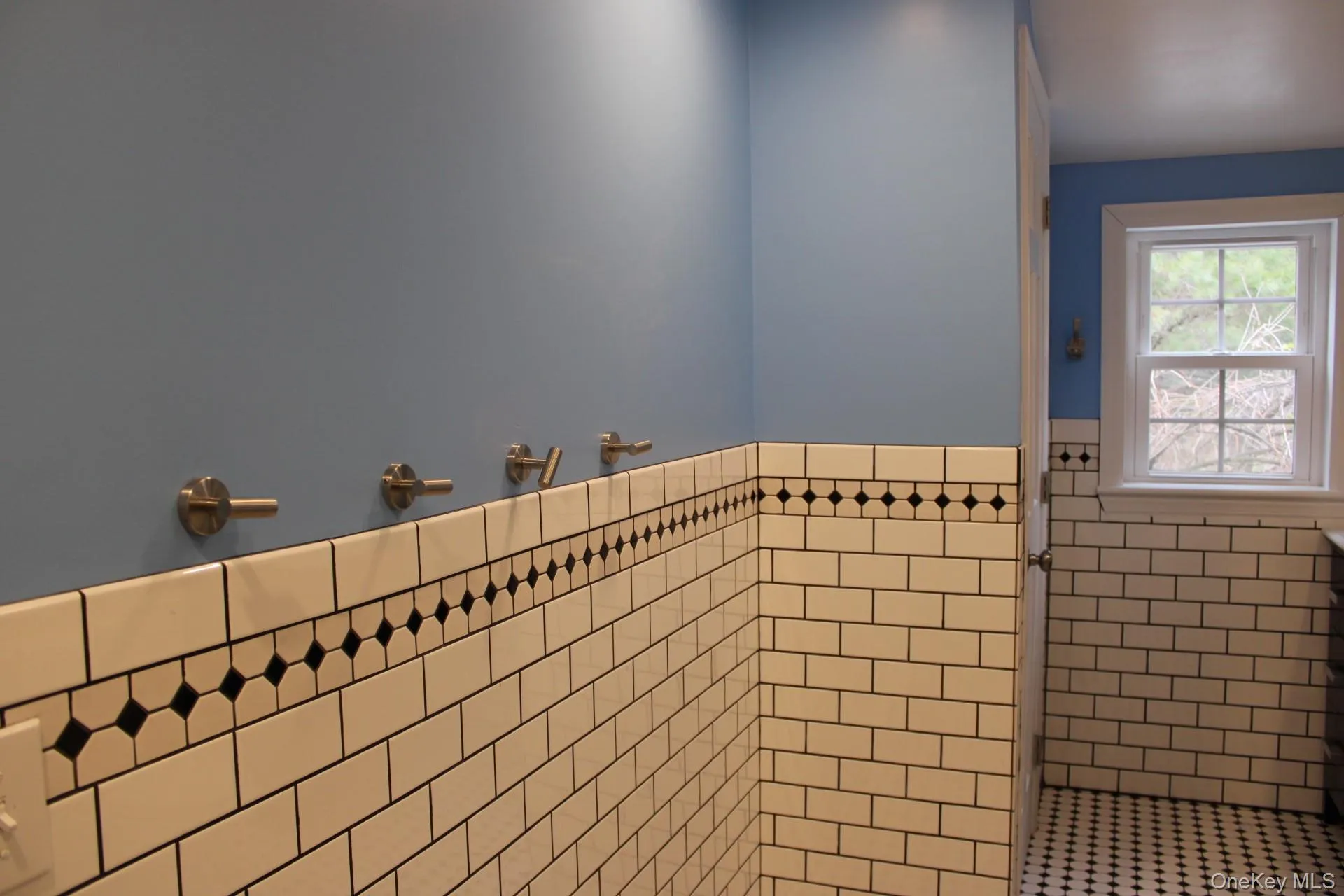 Bathroom with tile walls and wainscoting Bathroom with tile walls and wainscoting