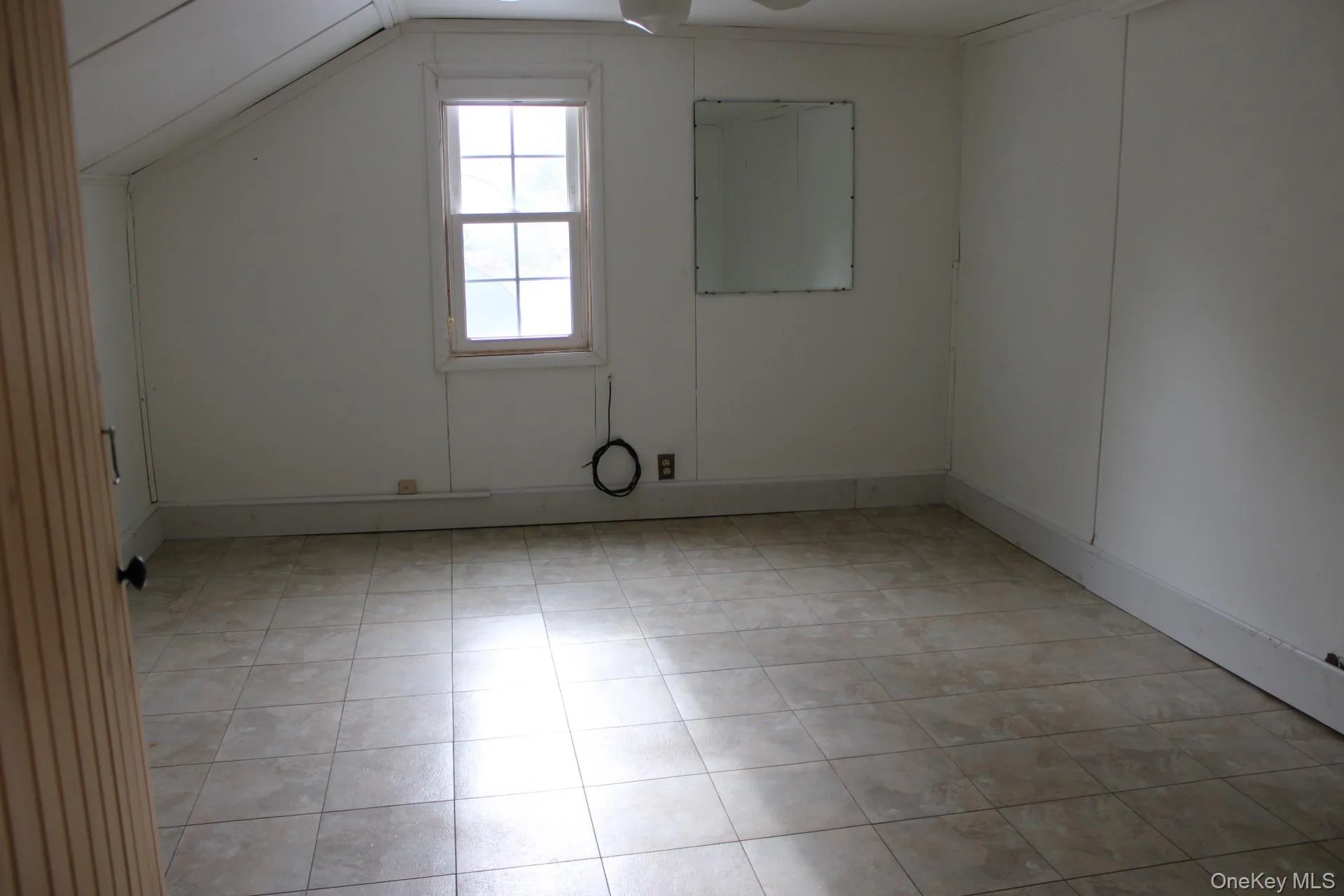 Additional living space with light tile patterned floors and baseboards Additional living space with light tile patterned floors and baseboards