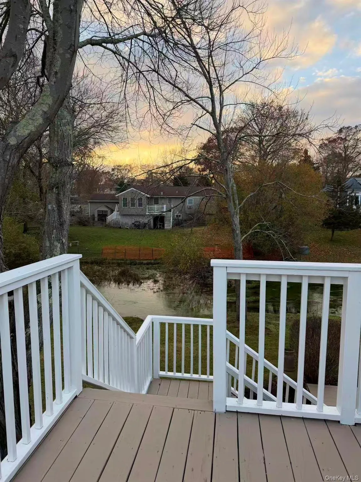 Deck at dusk with a yard Deck at dusk with a yard