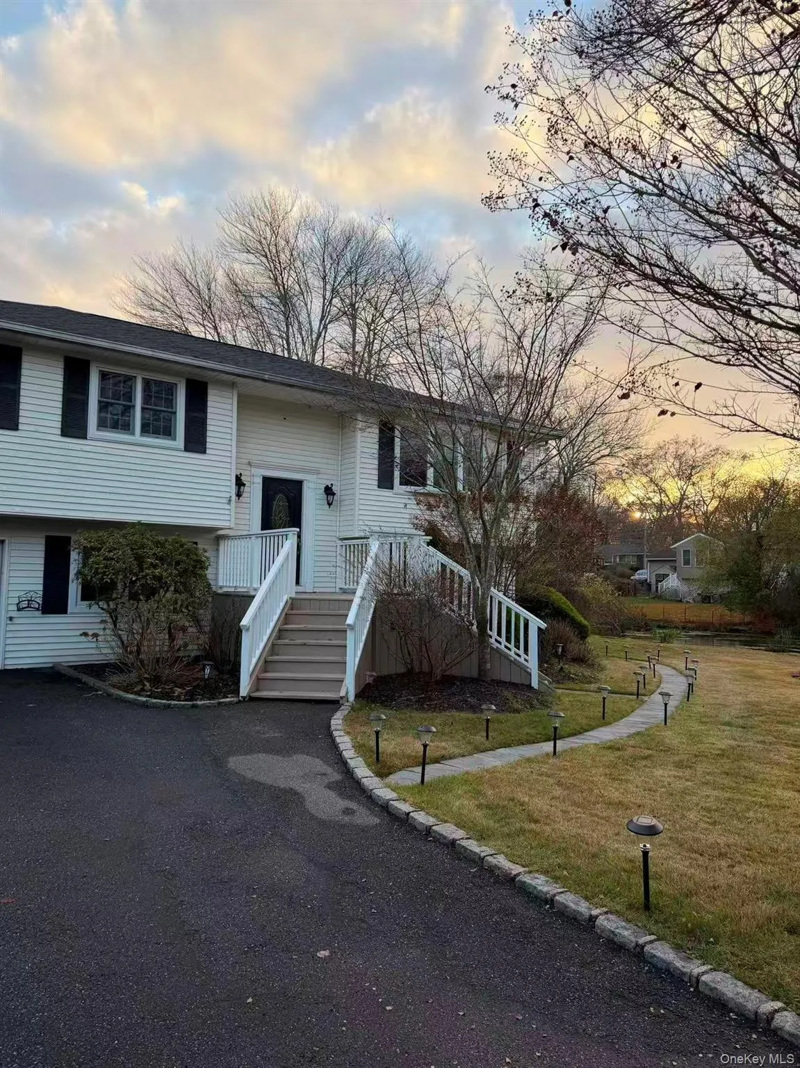 Raised ranch featuring a yard Raised ranch featuring a yard