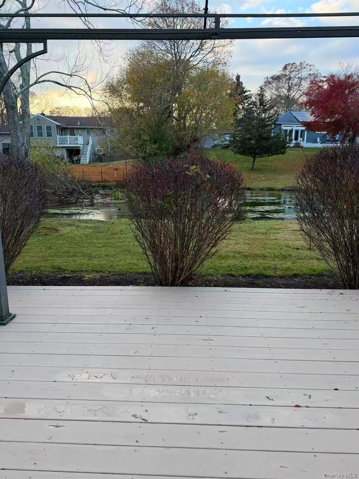 Wooden deck with a lawn and a water view Wooden deck with a lawn and a water view