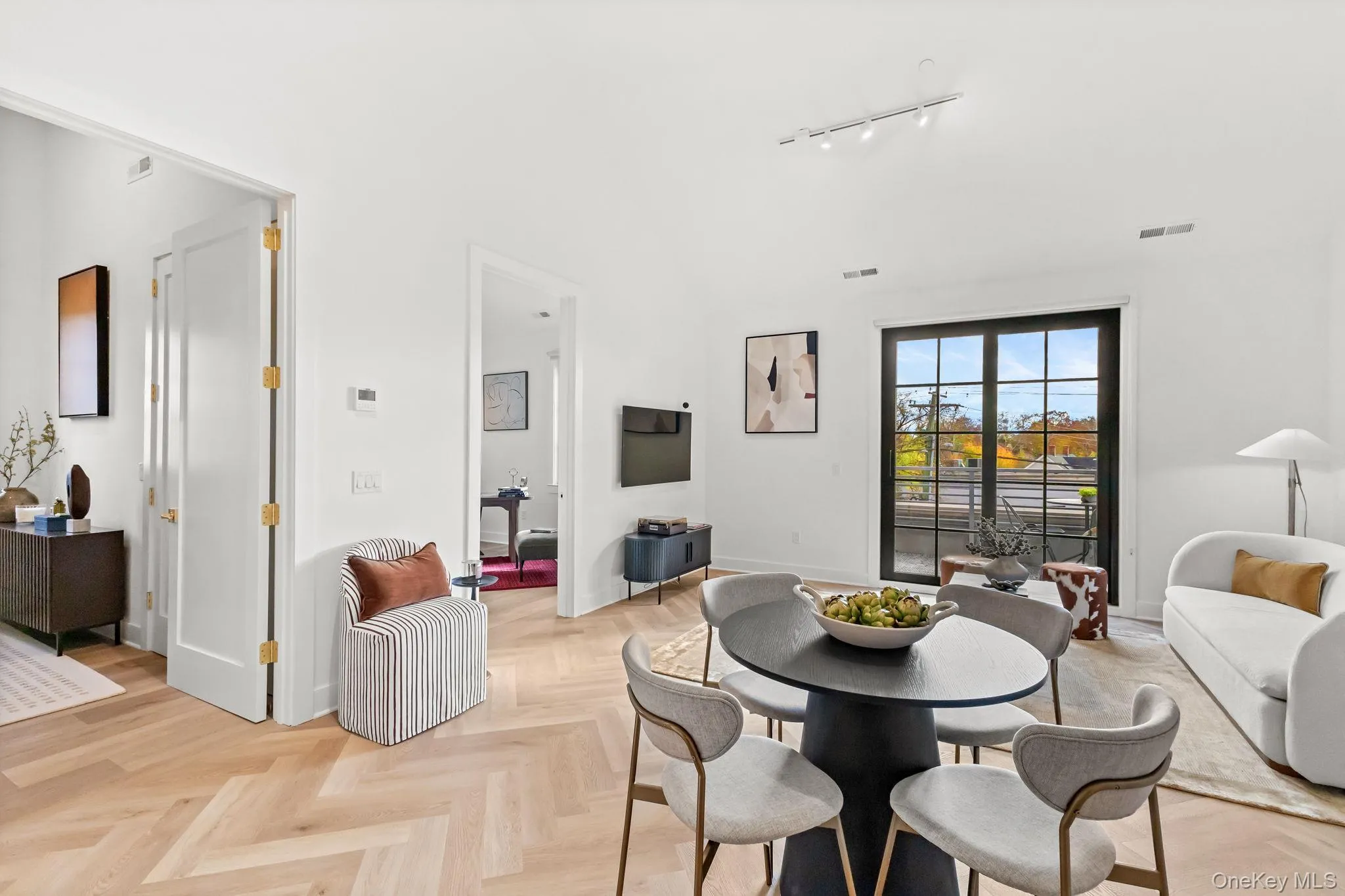 Dining area with vaulted ceiling and track lighting Dining area with vaulted ceiling and track lighting