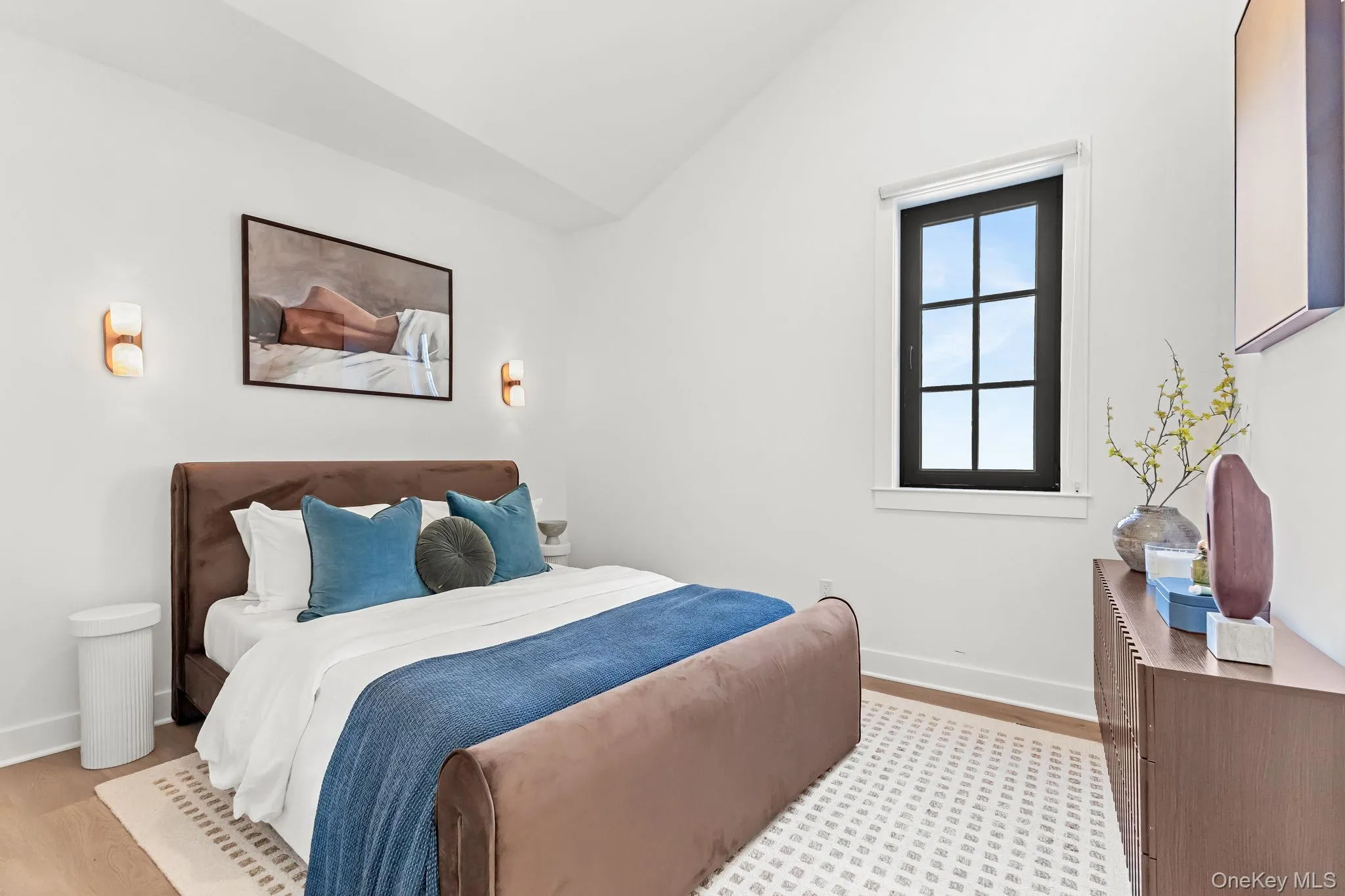 Bedroom with lofted ceiling and light wood-style floors Bedroom with lofted ceiling and light wood-style floors