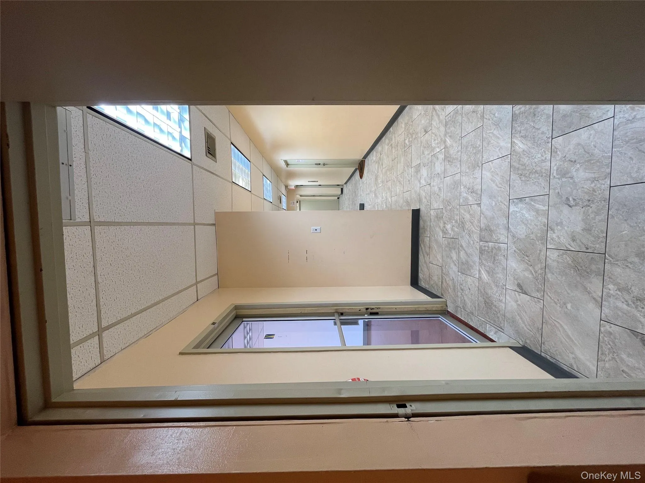 Hall featuring a drop ceiling and baseboards Hall featuring a drop ceiling and baseboards