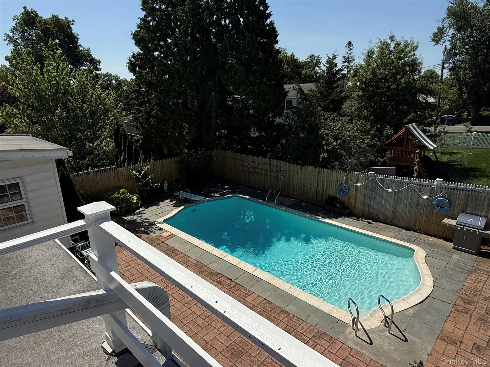View of pool from bedroom deck with a patio area and a fenced backyard View of pool from bedroom deck with a patio area and a fenced backyard