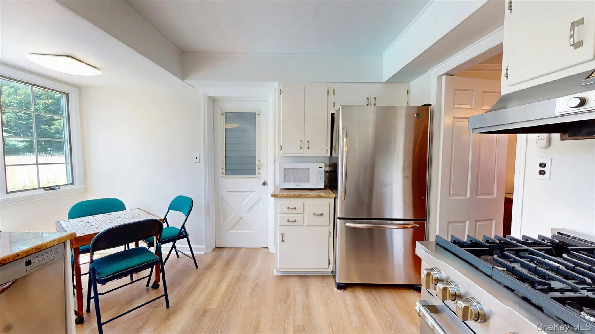 Kitchen featuring NEW 36" stainless steel range, ventilation hood, and SS Refrigerator Kitchen featuring NEW 36" stainless steel range, ventilation hood, and SS Refrigerator
