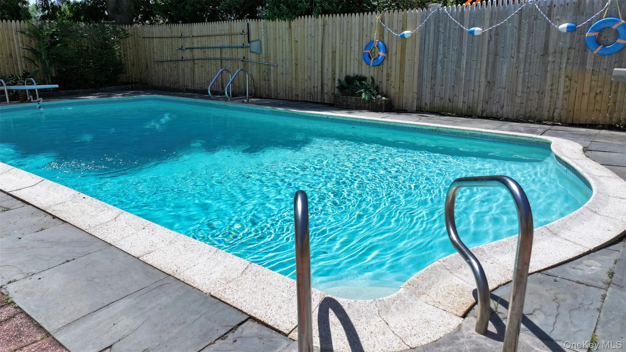 View of swimming pool with a fenced backyard View of swimming pool with a fenced backyard
