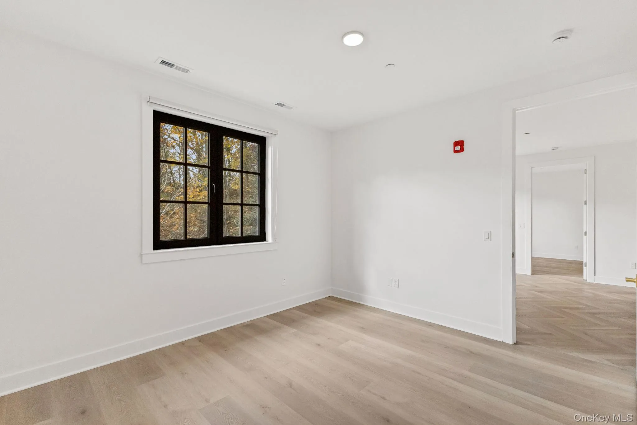 Unfurnished room with light wood-style floors and recessed lighting Unfurnished room with light wood-style floors and recessed lighting