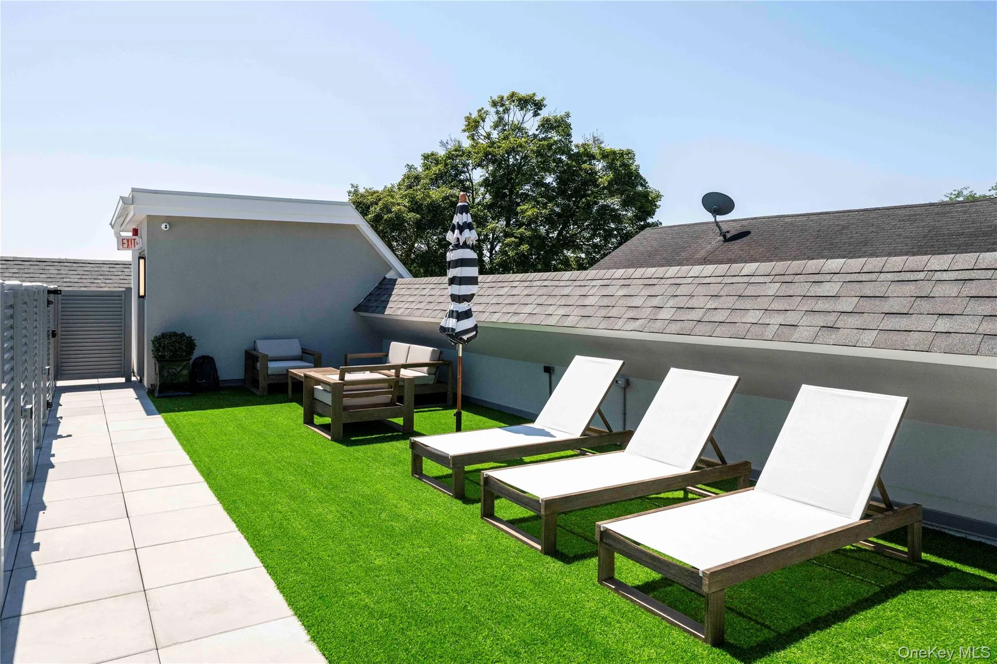 View of grassy yard featuring a patio and outdoor lounge area View of grassy yard featuring a patio and outdoor lounge area