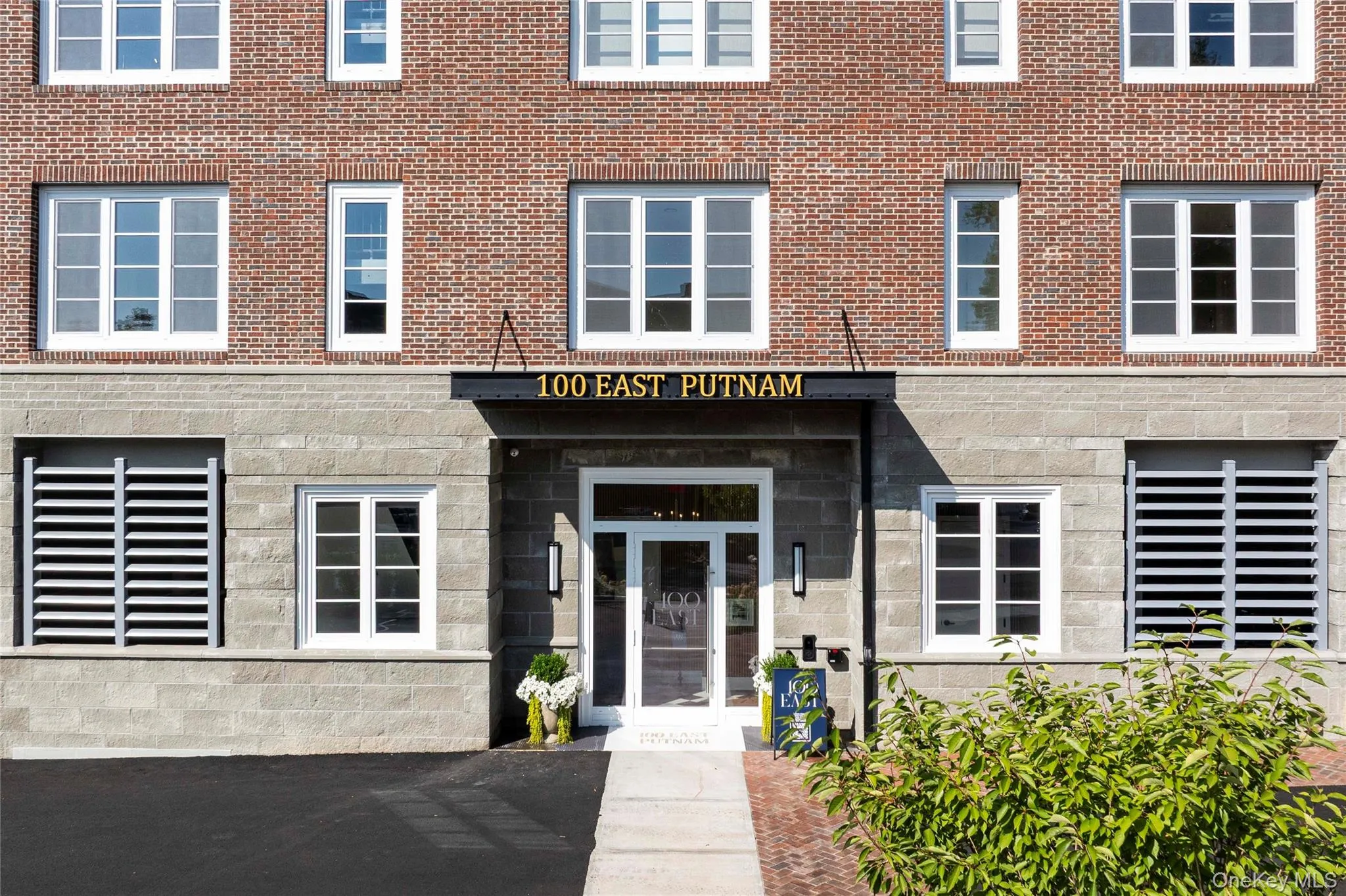 Doorway to property featuring stone siding and brick siding Doorway to property featuring stone siding and brick siding