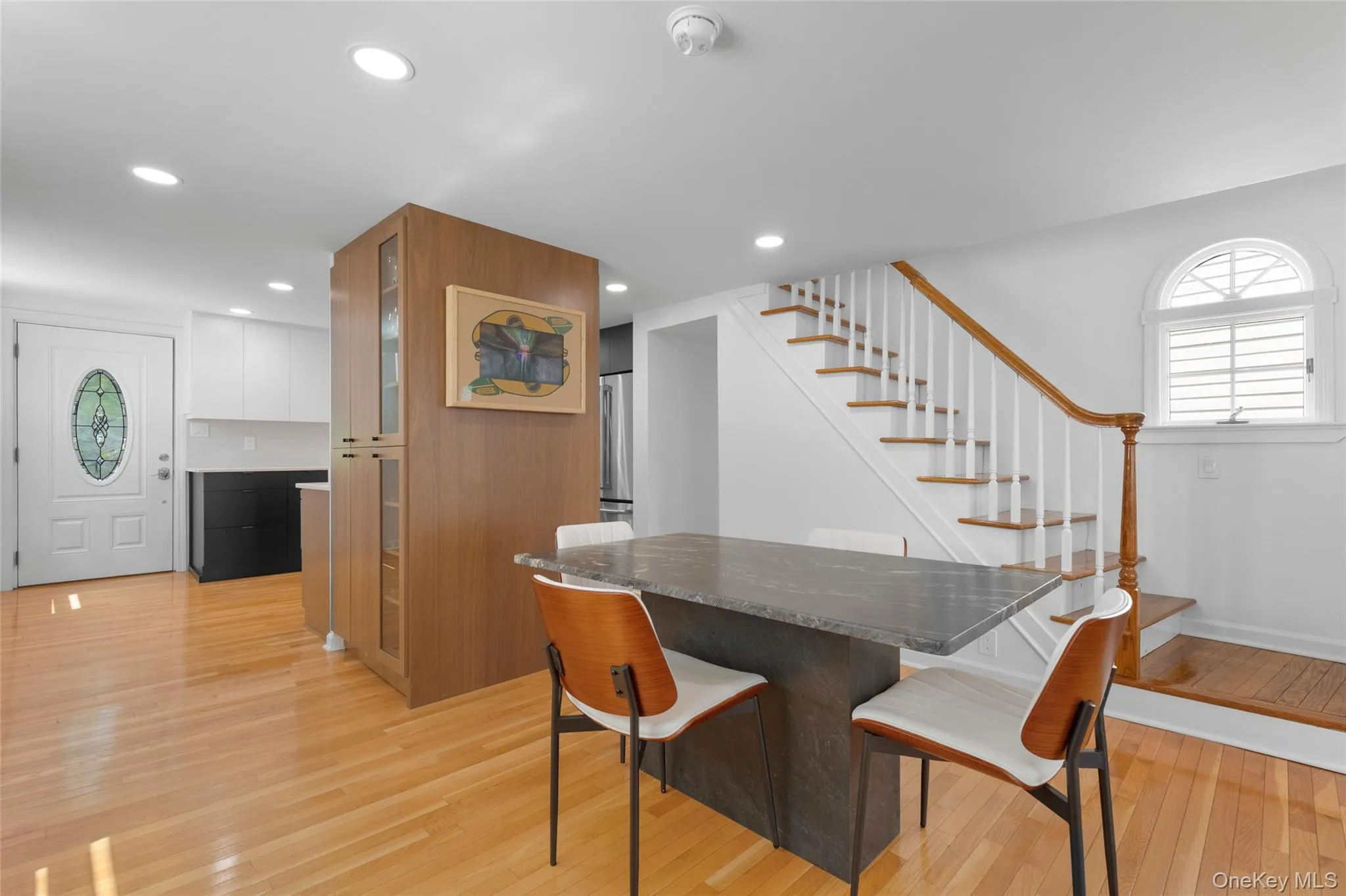 Dining room with plenty of natural light, light wood-type flooring, stairway, and recessed lighting Dining room with plenty of natural light, light wood-type flooring, stairway, and recessed lighting