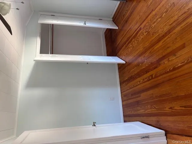Unfurnished bedroom with a ceiling fan, dark wood-style floors, crown molding, and a closet Unfurnished bedroom with a ceiling fan, dark wood-style floors, crown molding, and a closet