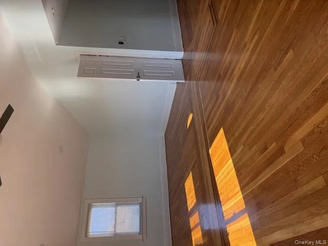 Unfurnished room featuring dark wood-style flooring, ceiling fan, and lofted ceiling Unfurnished room featuring dark wood-style flooring, ceiling fan, and lofted ceiling