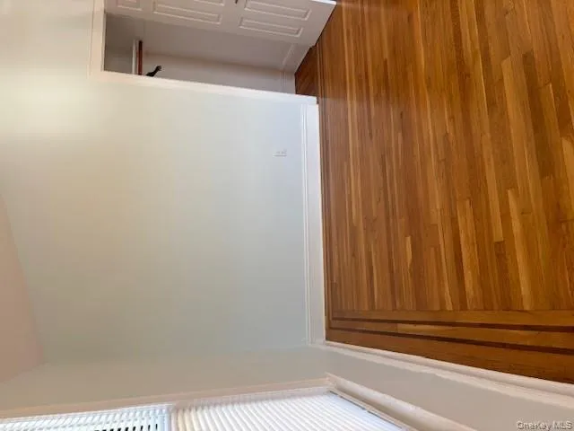 Unfurnished bedroom featuring wood finished floors and a closet Unfurnished bedroom featuring wood finished floors and a closet