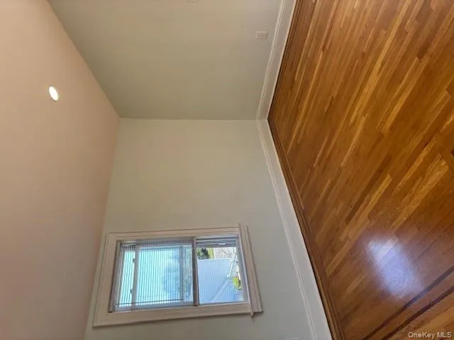 Empty room featuring dark wood-type flooring and recessed lighting Empty room featuring dark wood-type flooring and recessed lighting